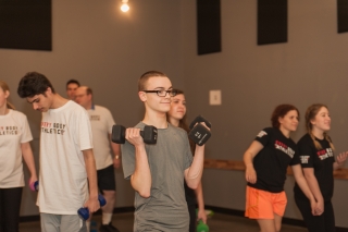 A person holding two 12-pound weights in each hand