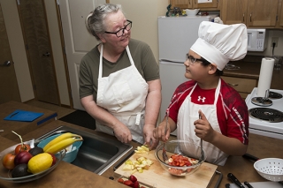 A boy and a woman cooking together